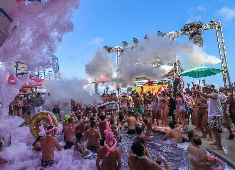 Cancún: Coco Bongo Beach Party Experience - A beach party with a stage-sized show