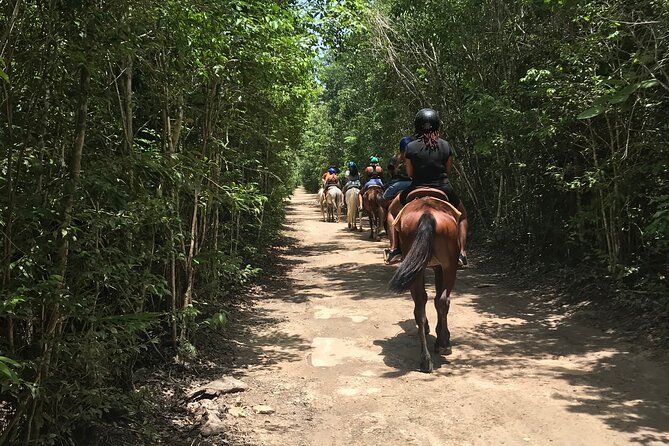 Horseback Riding plus ATV, Cenote, Ziplines, and Lunch - ATV riding on a muddy jungle route