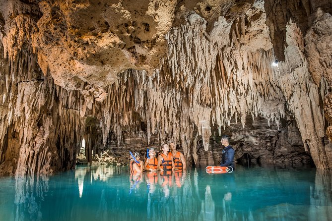 Magical Cenote and Paradise Lagoon Snorkeling Adventure - Entering the cenote through rock and darkness