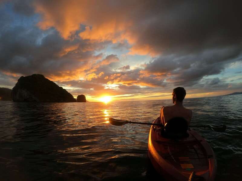 Mismaloya: Los Arcos Bioluminescent Waters Kayak & Cave Tour - Paddling toward Los Arcos at sunset
